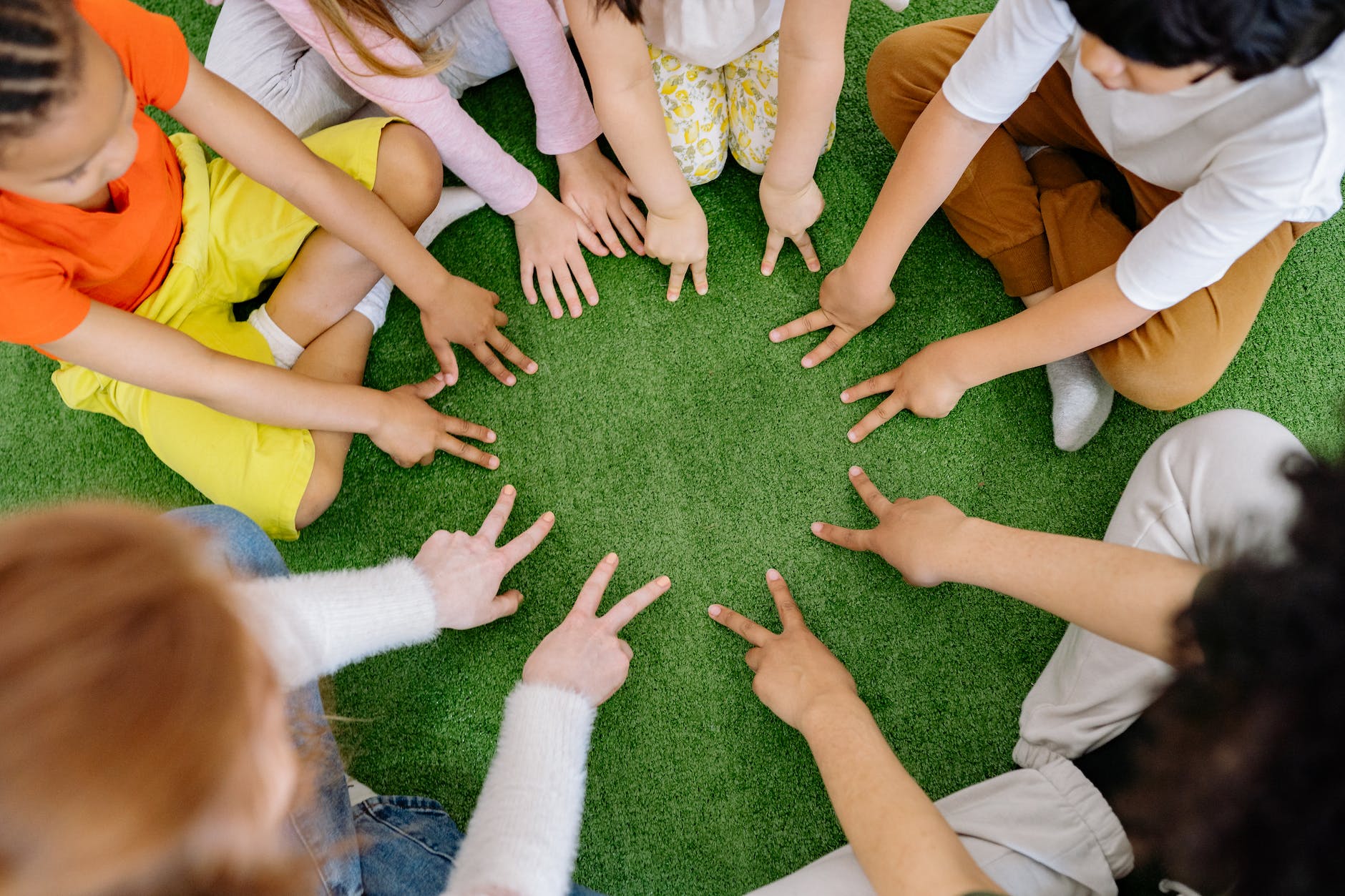 group of children playing on green grass