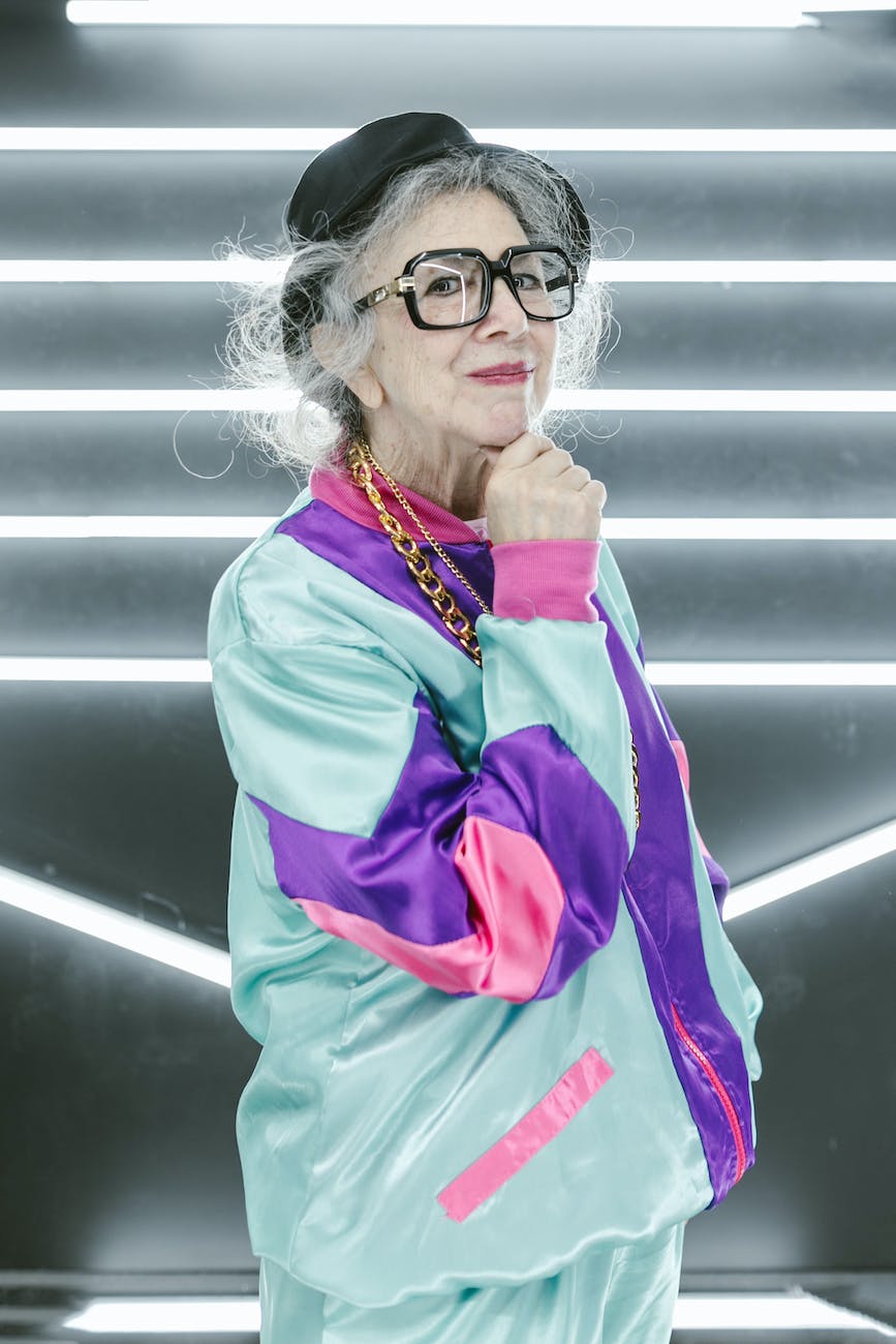 woman in red and green zip up jacket wearing eyeglasses